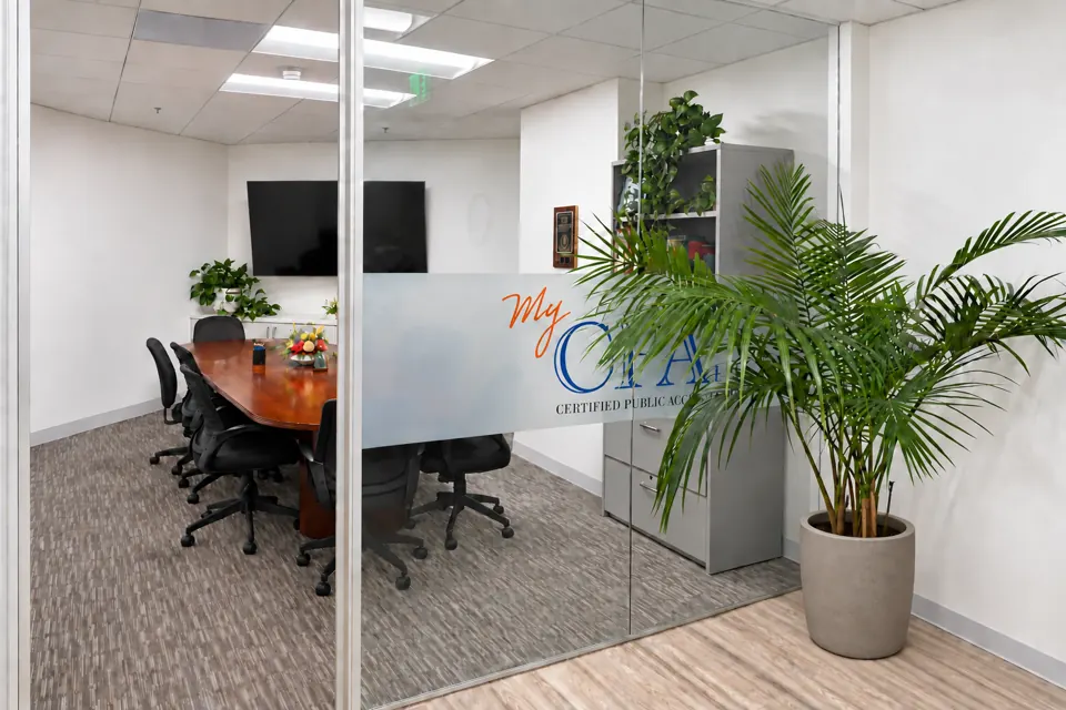 MyCPA conference room with a meeting table, glass partition and firm signage in Woodland Hills